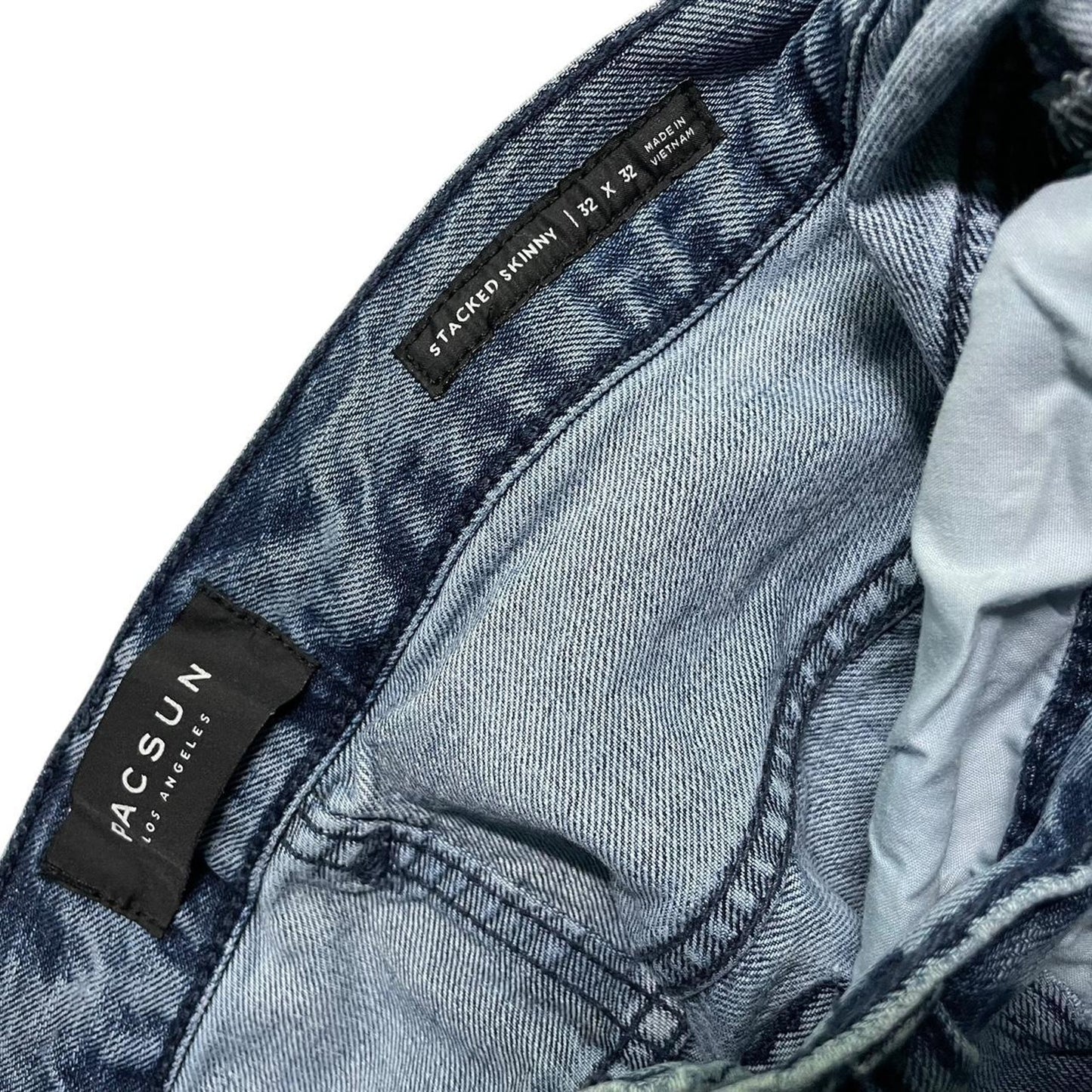 Distressed blue denim jeans