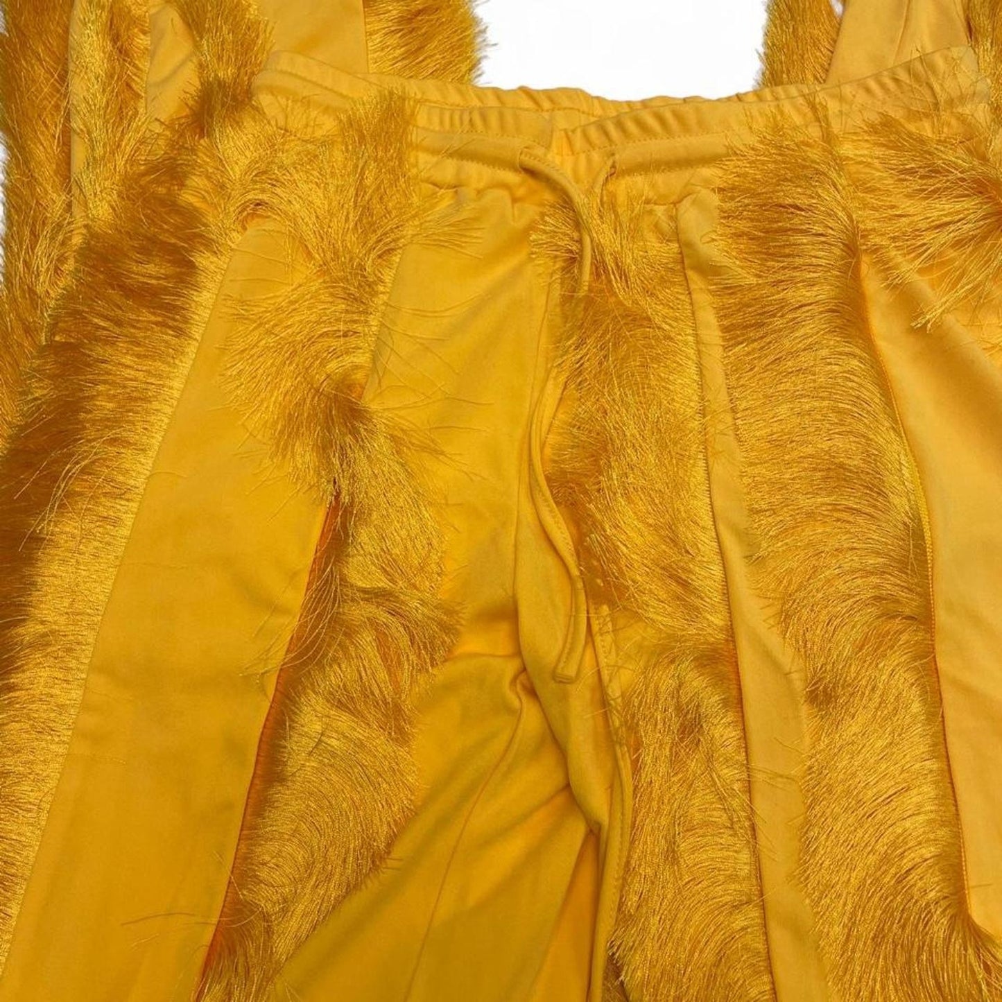 Yellow feathered sweatpants with fringe