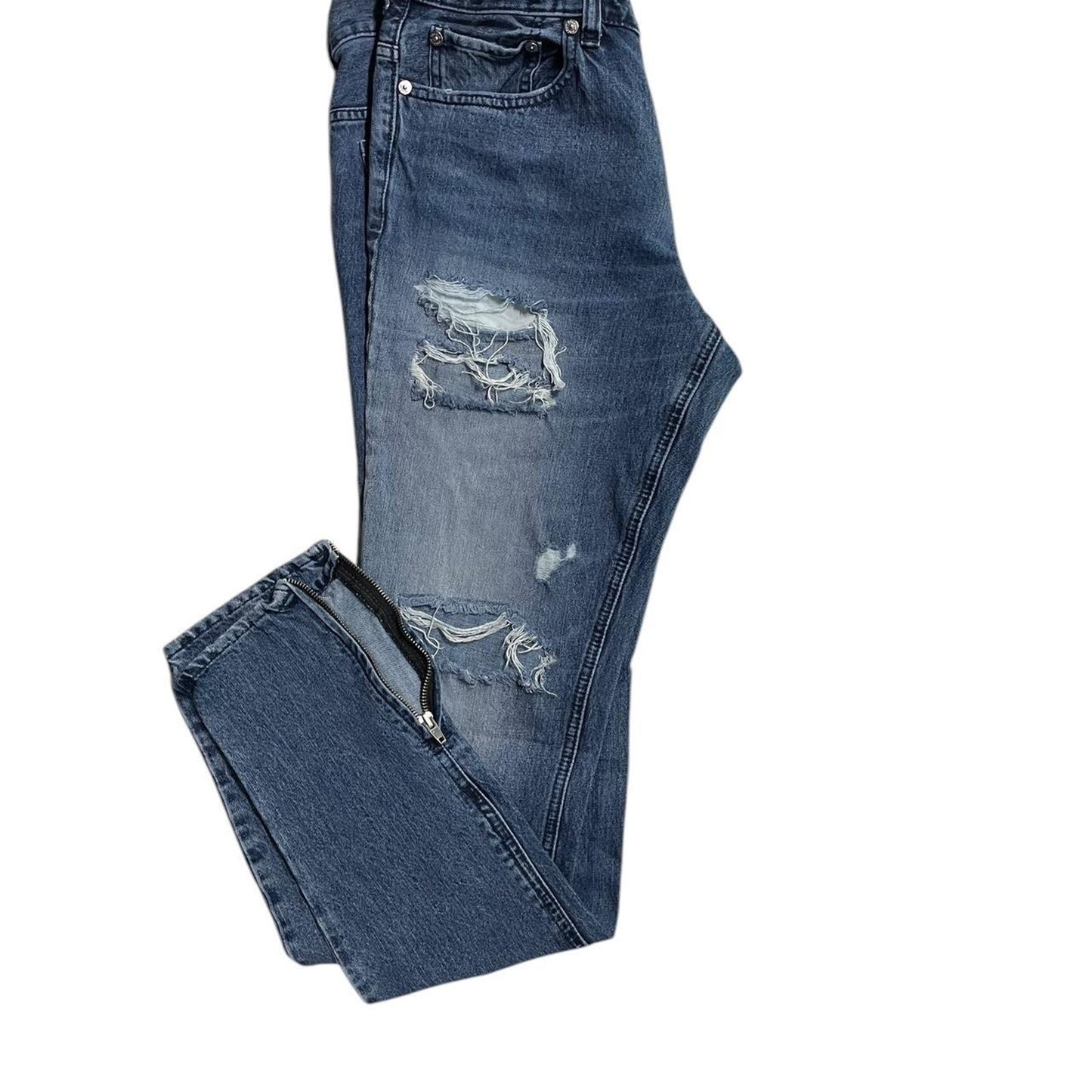 Distressed blue denim jeans