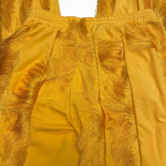 Yellow feathered sweatpants with fringe