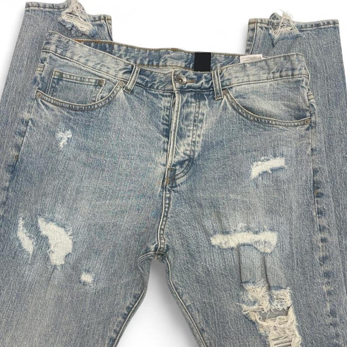 Light wash distressed denim jeans