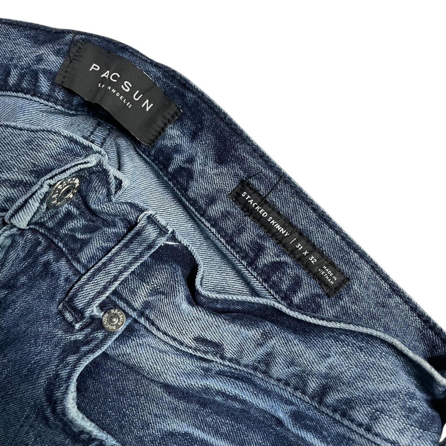 Distressed blue denim jeans
