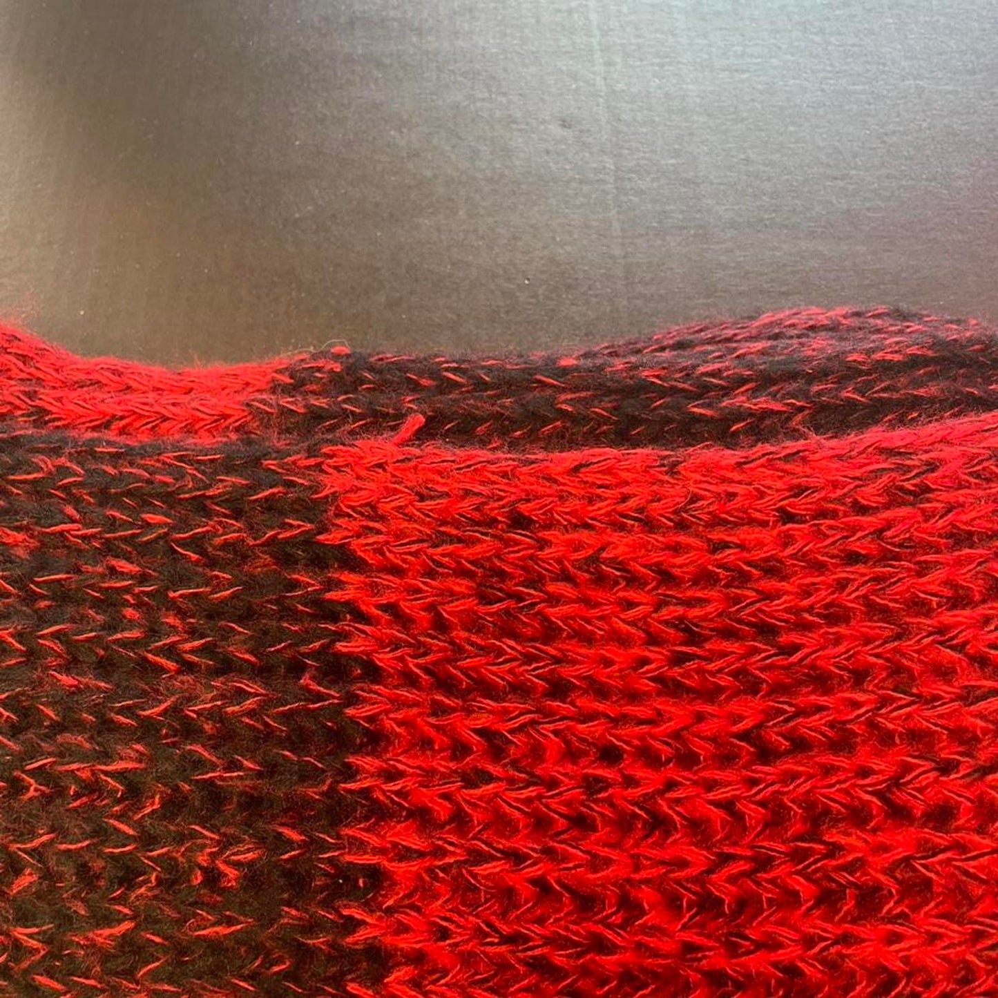 Red and black knitted scarf