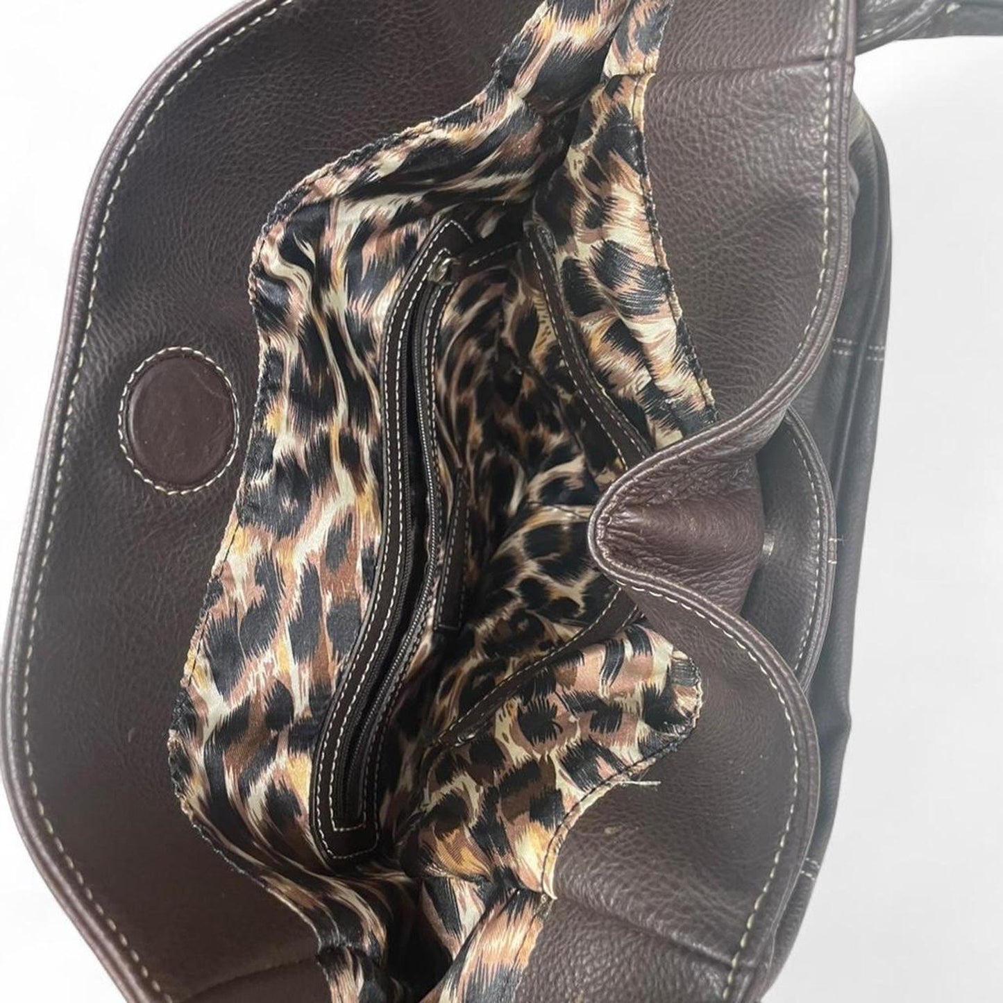 Brown leather handbag with leopard inside